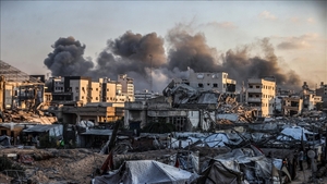 Israel kills 10 Palestinians by bombing two houses in central Gaza.